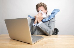 Blowing Nose in Front of Laptop