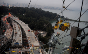 Ironworkers removing cable wrapping machine from the south-side span at dusk (winter 2012)