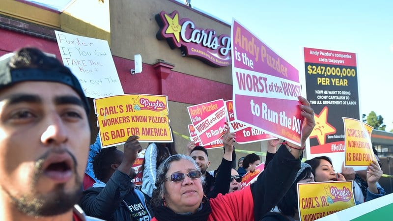 Fast-food workers in L.A. on Thursday protest against restaurant-chain mogul Andrew Puzder, who has been tapped as President Donald Trump's nominee for labor secretary.