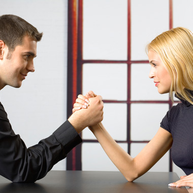 gender in workplace man and a woman arm wrestling