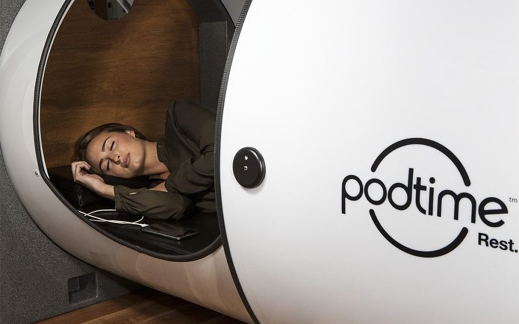 office napping pod with a woman inside sleeping