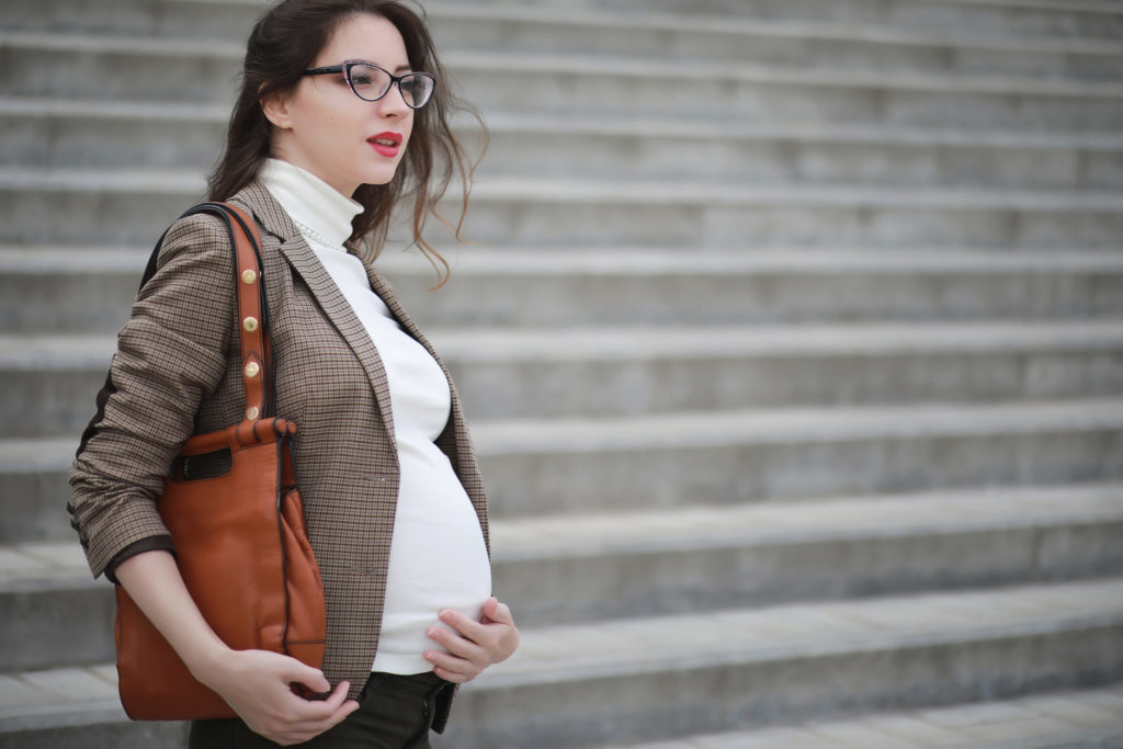 Pregnant employee in front of steps