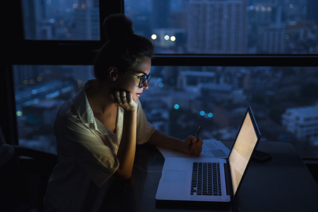 woman working overtime late at night on her laptop