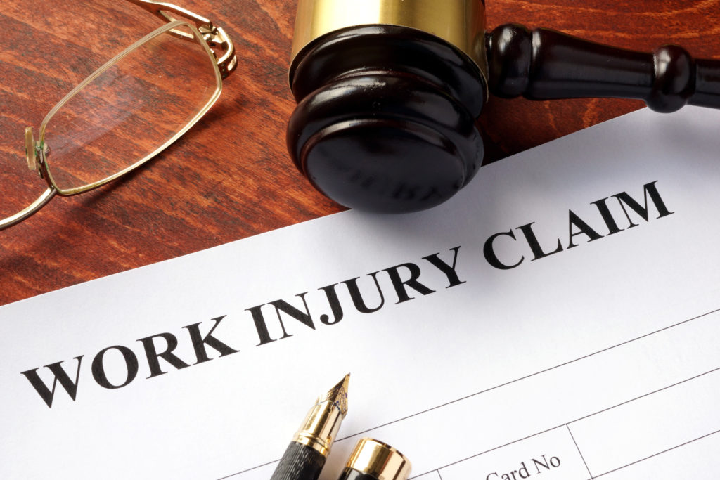 gavel and glasses on a work injury claim