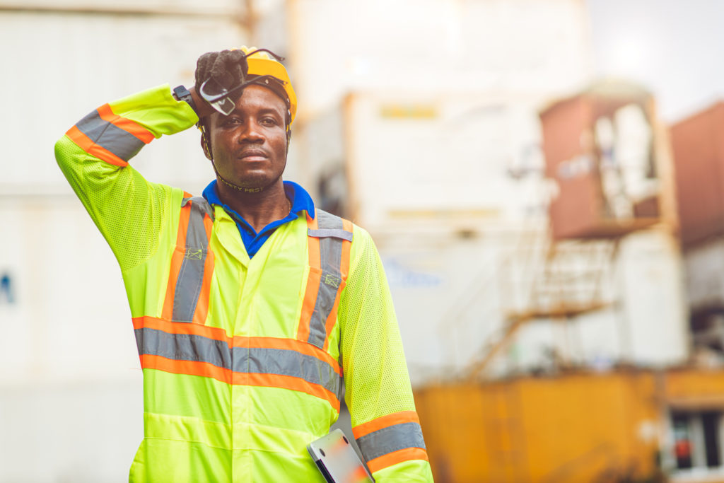 worker wiping brow during excessive heat wave