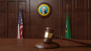 Washington State Courtroom with gavel and flag, Silenced No More Act - Emery Reddy Employment Attorneys Seattle