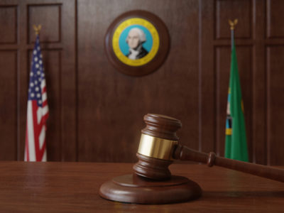 Washington State Courtroom with gavel and flag, Silenced No More Act - Emery Reddy Employment Attorneys Seattle