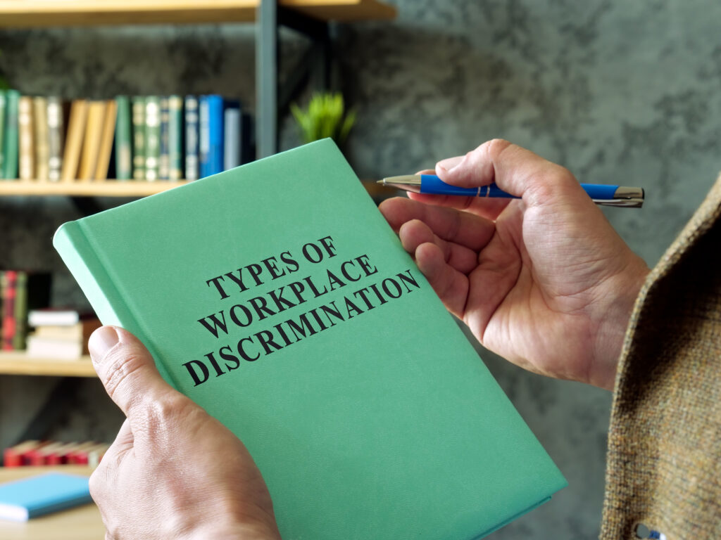 Manager holds book types of workplace discrimination Manager holds book types of workplace discrimination caste discrimination types of workplace discrimination workers rights