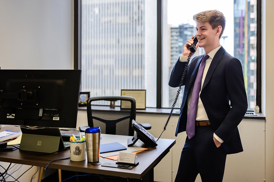 Calum Bryant on the phone with a client in our Seattle office