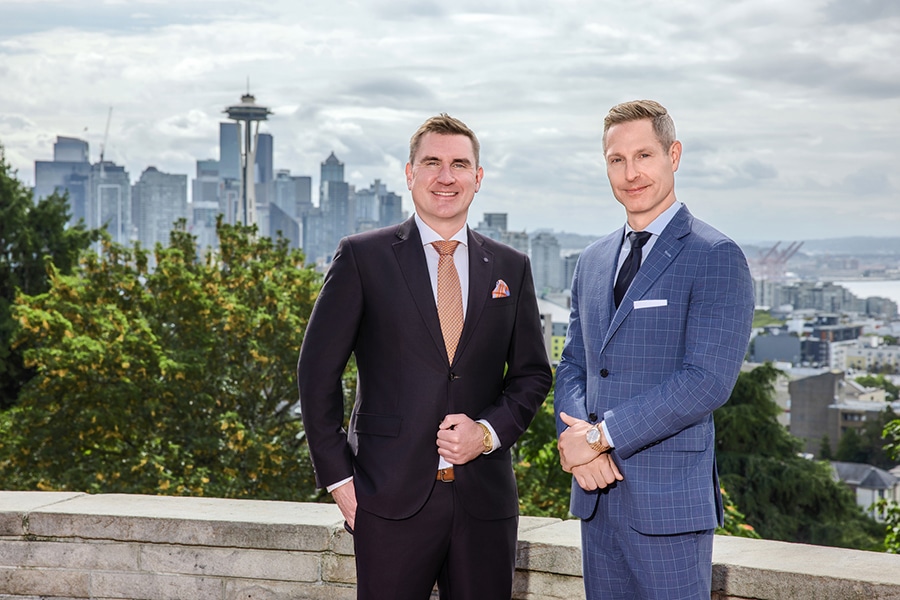 Patrick Reddy and Timothy Emery in front of the Seattle skyline
