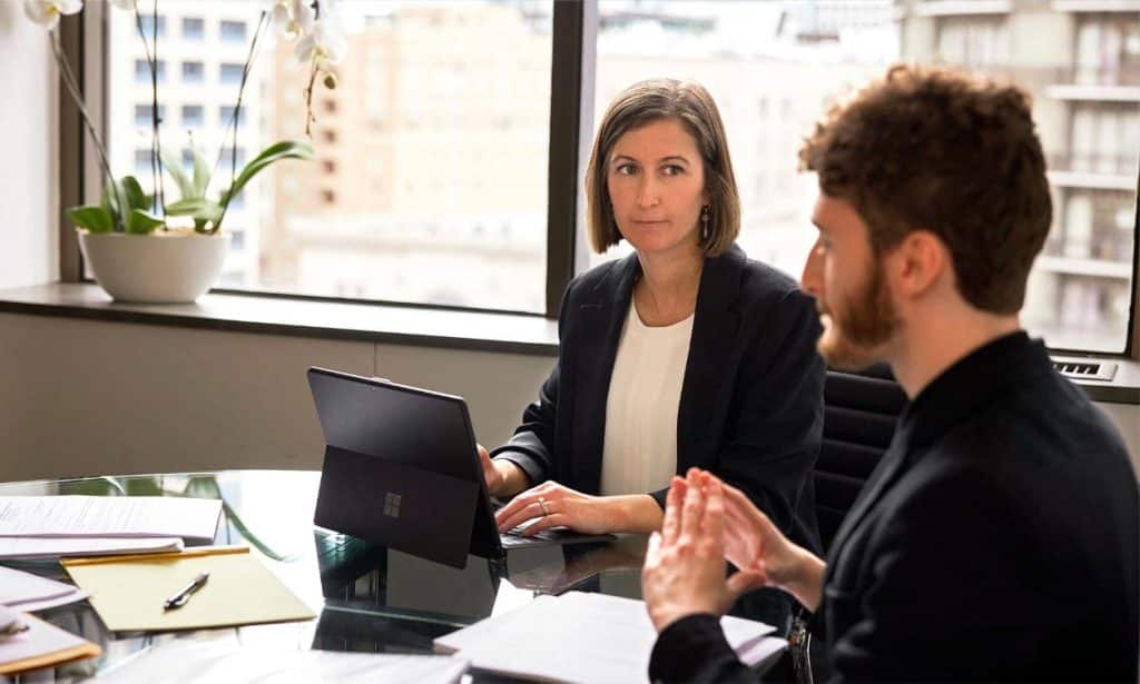 Legal professional discussing a Workers' Compensation case at Emery Reddy office.