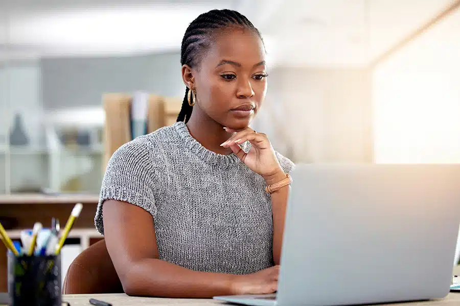 A woman reopening a workers compensation claim from her computer.