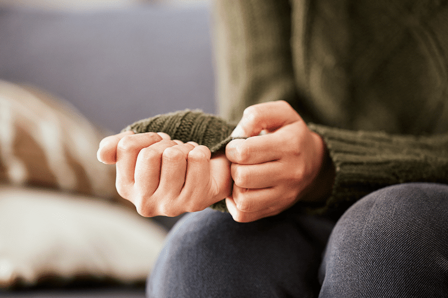 workplace anxiety and axiety causing someone to pull at their shirtsleeve