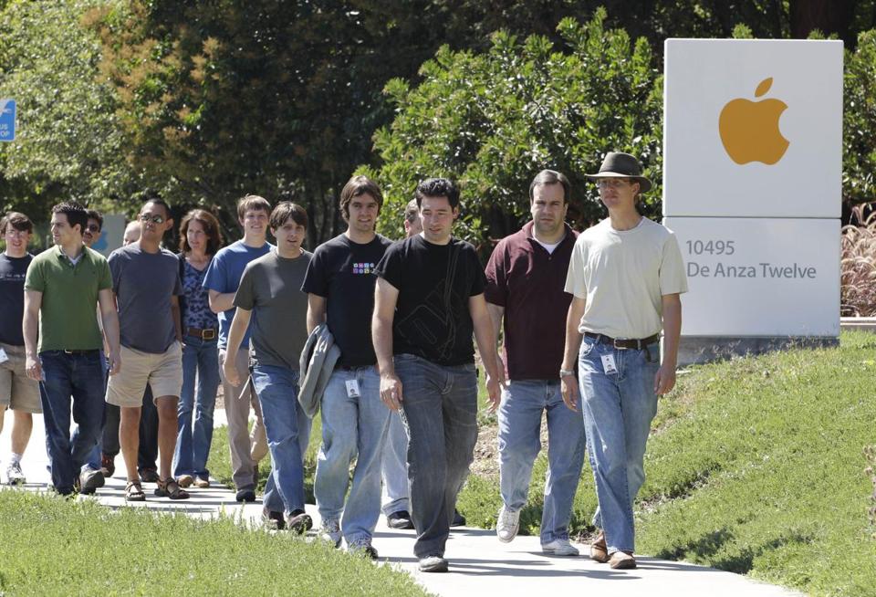 men in tech in front of apple logo