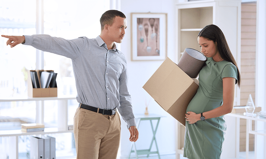 pregnant worker being fired and carrying a box out