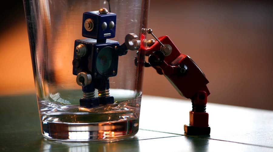 one robot in a glass and one robot outside looking in