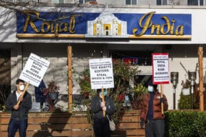 A Seattle Solidarity Network group pickets the Royal India in Kirkland in January 2024 as a part of a campaign to raise awareness of wage theft. (Ken Lambert / The Seattle Times)