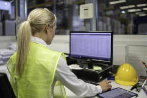 light duty worker in a warehouse using a computer