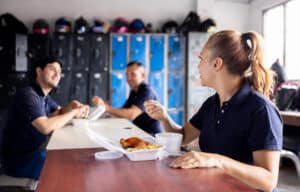 Happy group of Latin American blue-collar workers eating in their lunch break - working class concepts