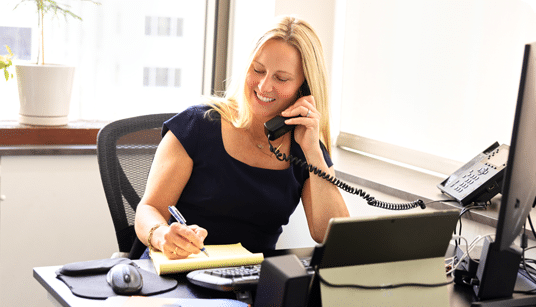 Workers Compensation attorney Karolina Arthur on the phone with a client