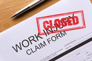 closed work injury claim form on the table