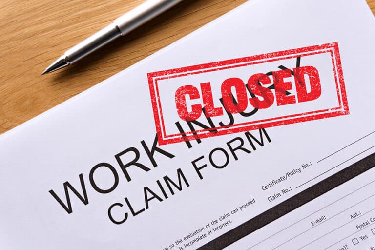 closed work injury claim form on the table