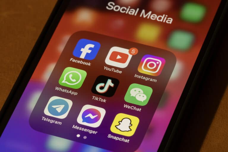 Some of the most popular social media apps by number of monthly active users, including Facebook, YouTube, Instagram, WhatsApp, TikTok, WeChat, Telegram, Messenger, and Snapchat, are seen on an iPhone.
