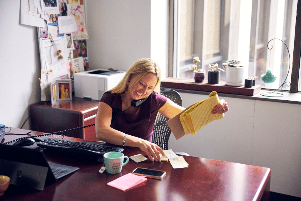 karolina arthur in her office on the phone with a client in the emery reddy downtown seattle offices