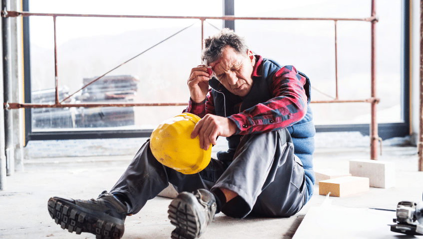 Construction worker sitting on the ground